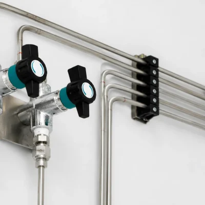 Close-up of laboratory isolation valves and stainless-steel tubing