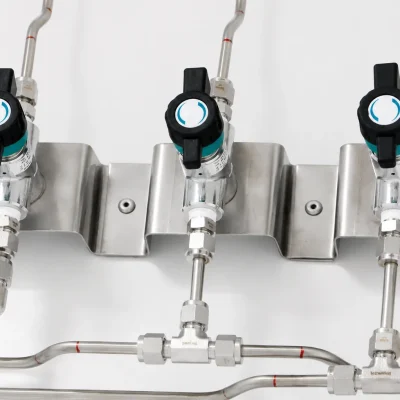 Close-up of three laboratory isolation valves and distribution tubing