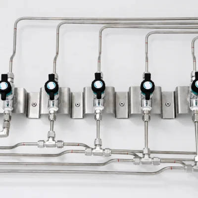 Row of laboratory isolation valves connected to stainless-steel gas lines