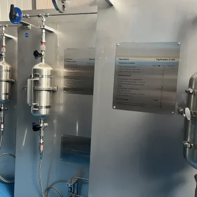 Multiple stainless-steel sampling cylinders installed on laboratory panels