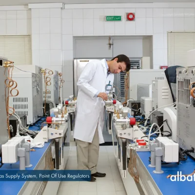Laboratory operator working with gas chromatographs and point-of-use gas regulators