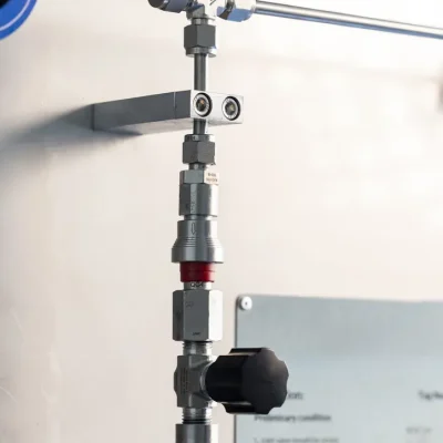 Inlet connection and valve above a wall-mounted sampling cylinder
