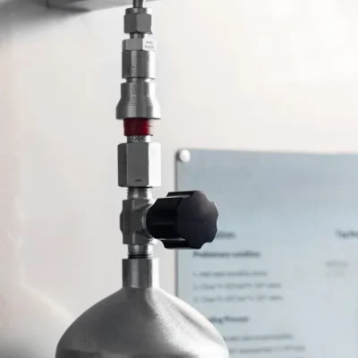 Upper valve assembly connected to a stainless-steel sampling cylinder